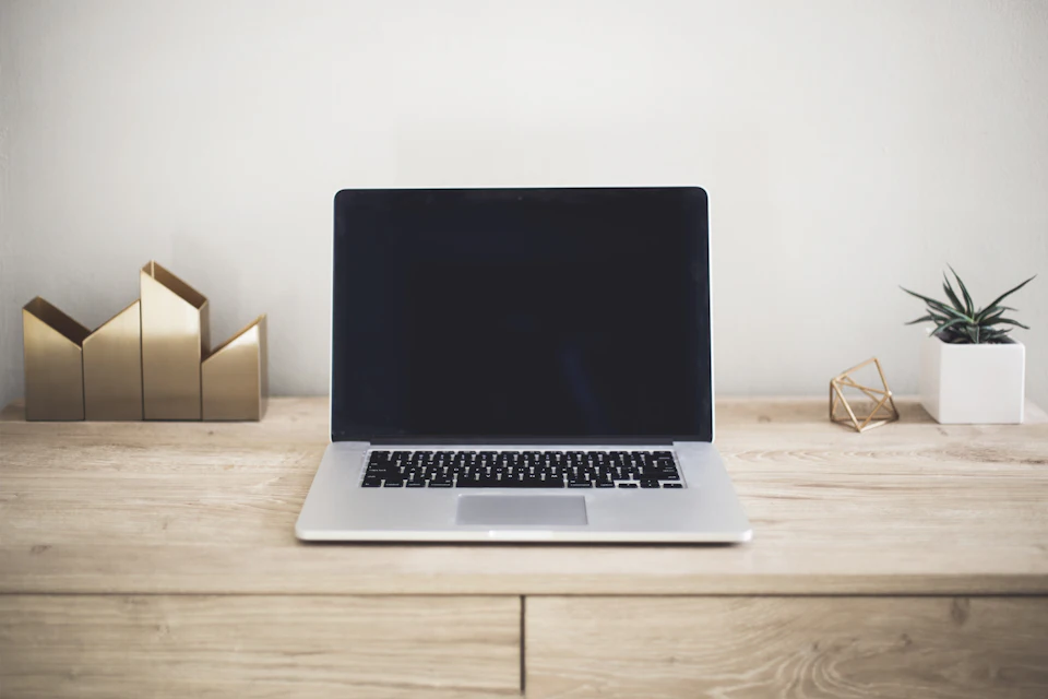 Laptop on a brown wooden table